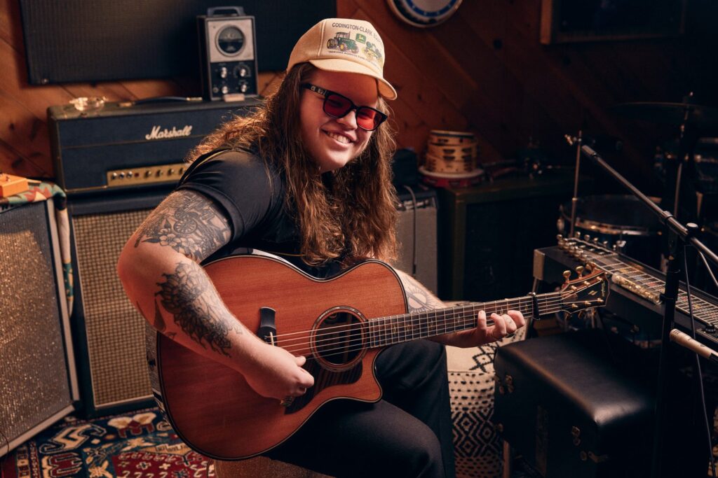 Video thumbnail image of musician Marcus King in a studio holding a Taylor acoustic guitar
