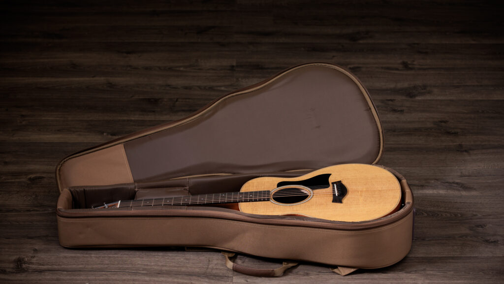 Image of a Taylor GS Mini Sapele acoustic guitar in a padded guitar gig bag