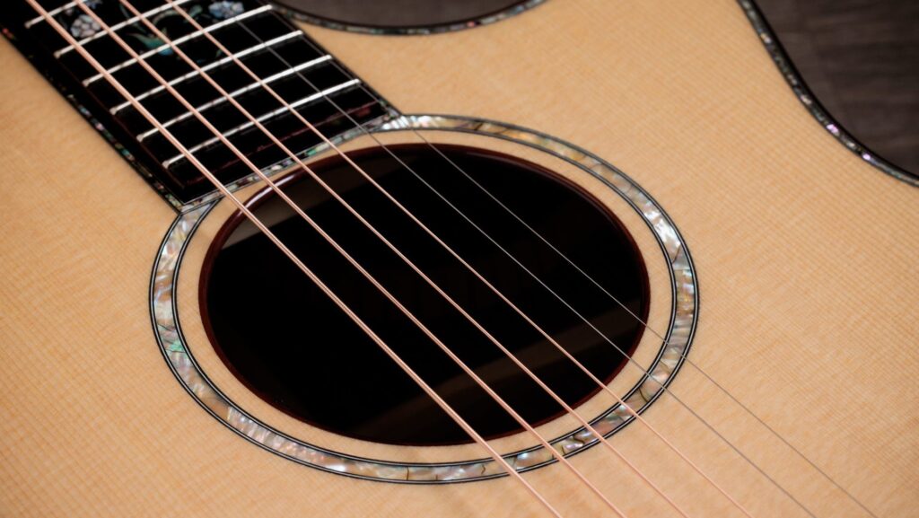 Detail image of a Taylor Legacy 914ce acoustic-electric guitar's soundhole with abalone rosette