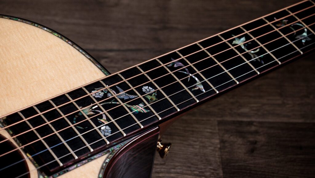 The abalone Cindy fretboard inlay on a Taylor Legacy 914ce acoustic-electric guitar