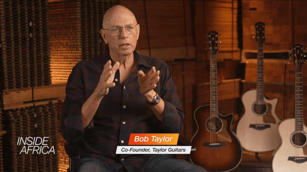 Taylor Guitars founder Bob Taylor sits in a room with acoustic guitars in the background and the logo for CNN Inside Africa in the foreground
